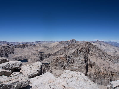 landscape photography of mountains under blue sky thumbnail