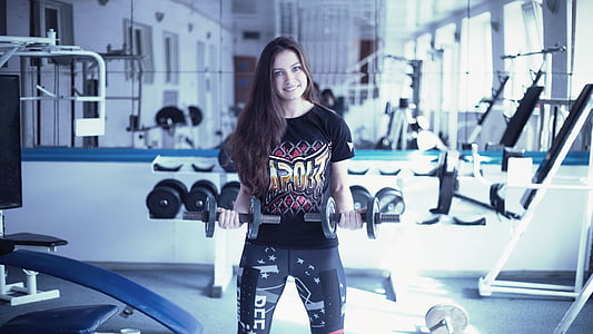 woman holding two black dumbbells thumbnail
