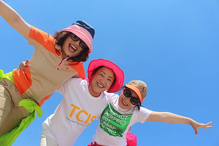 three woman taking a group picture thumbnail