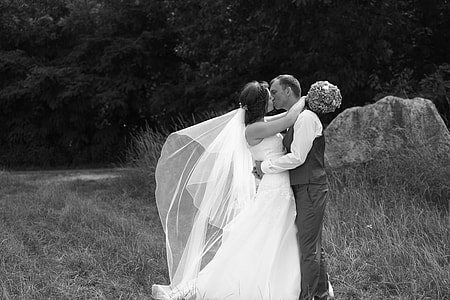 grayscale photo of newly wedding couple kissing thumbnail