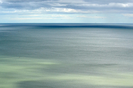 ocean under cloudy sky during daytime thumbnail
