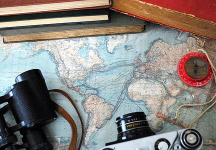 high-angle photo of DSLR camera, binoculars, compass, and books on top of map thumbnail