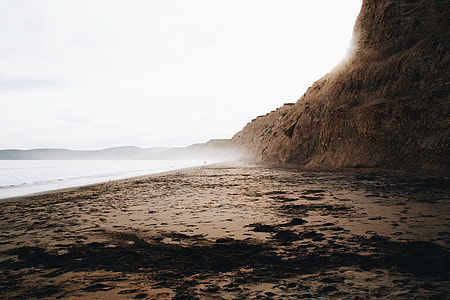 mountain cliff near body of water landscape photo thumbnail