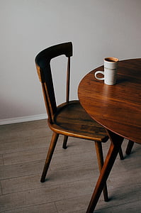 brown wooden chair beside white ceramic coffee mug thumbnail