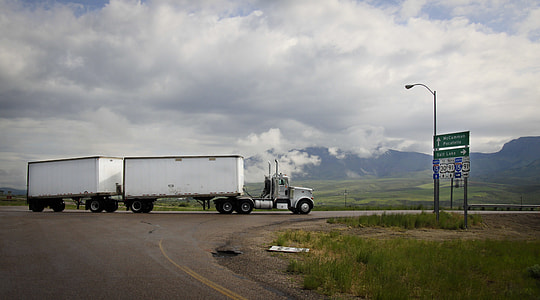 white and black truck near green grass field thumbnail