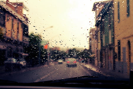 inside vehicle view of other vehicle on road between buildings thumbnail