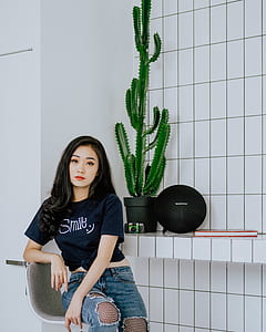 woman sitting beside cactus thumbnail