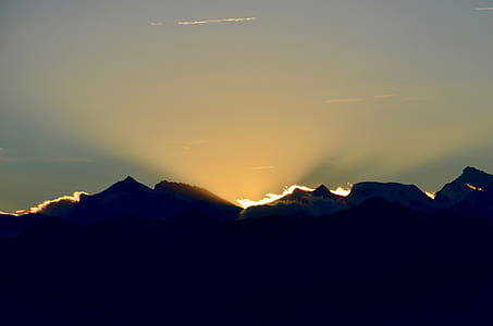 silhouette of mountain with sun rays thumbnail