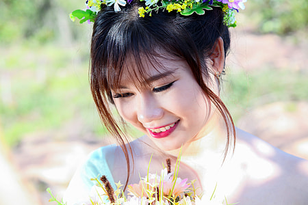 selective focus photography of smiling woman wearing flower headdress thumbnail