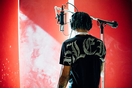 man standing near condenser microphone thumbnail