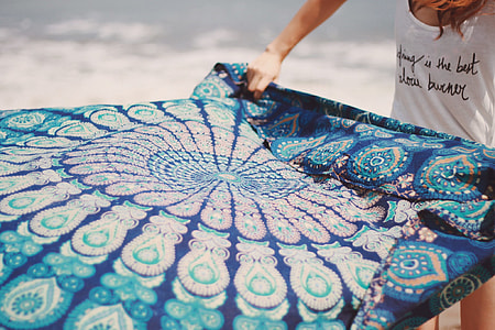 person holding blue floral textile thumbnail