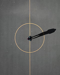 aerial photography of man standing on pavement thumbnail