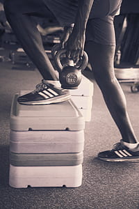 person holding 8KG kettlebell while exercising thumbnail