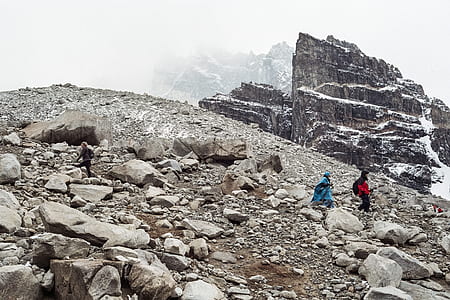 two girl walking on rock mountain hill during daytime thumbnail