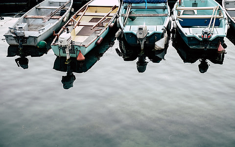 four assorted motor boat near shore thumbnail