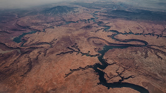 aerial photography of body of water near mountain thumbnail