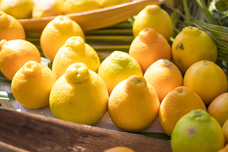 yellow lemons on brown wooden surface thumbnail