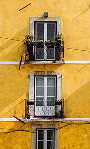 orange painted building with three storey window panels thumbnail
