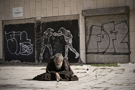 man in black top sitting on floor thumbnail