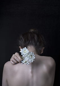person holding white flowers thumbnail