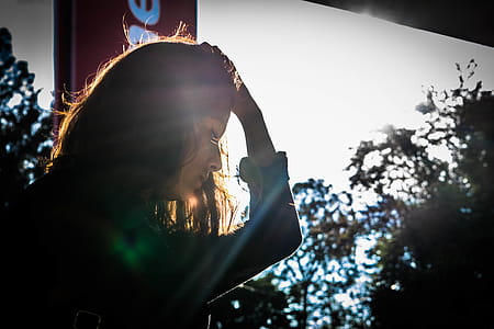 Woman Looking Holding While Holding Head With Left Hand thumbnail