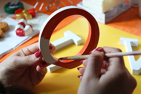 person painting a letter cutout thumbnail