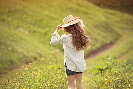 woman in white dress shirt standing on grass field during daytime thumbnail