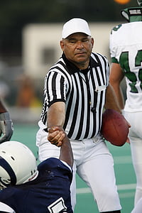 referee picking up football player thumbnail