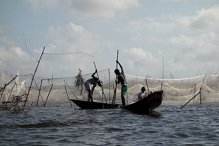 two person standing on top of boats thumbnail