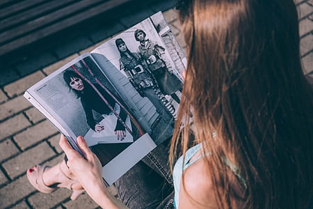 person reading entertainment magazine thumbnail