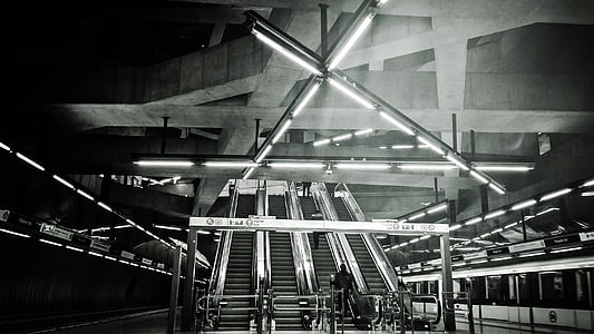 grascale photo of building interior with escalators thumbnail