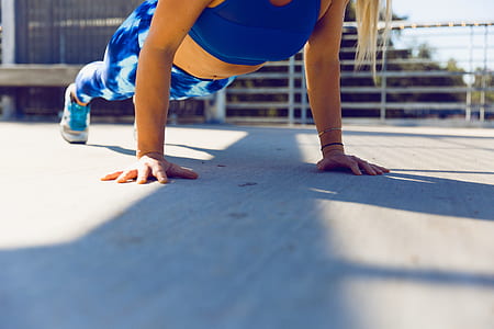 woman performing push-up during daytime thumbnail