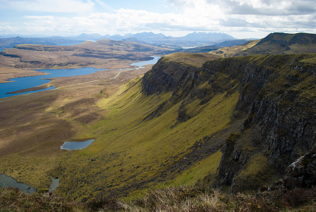 green cliff near body of water photography thumbnail