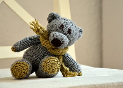 grey teddy bear plush toy on brown chair thumbnail
