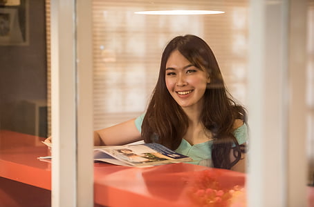 smiling woman through glass window thumbnail
