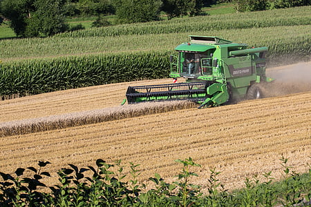 green and black farm tractor on field during daytime thumbnail
