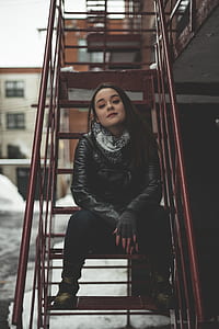 woman sitting on red metal ladder thumbnail