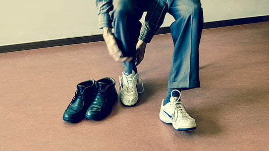 person wearing pair of white Nike sneakers thumbnail