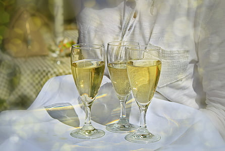 photo of three champagne glasses with champagne on white table cloth thumbnail