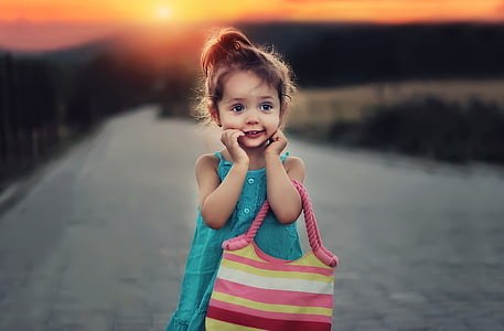 girl standing while holding bag thumbnail