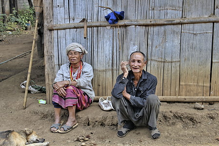 man and woman sitting on debris thumbnail