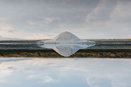 body of water with reflection of white piled sands thumbnail