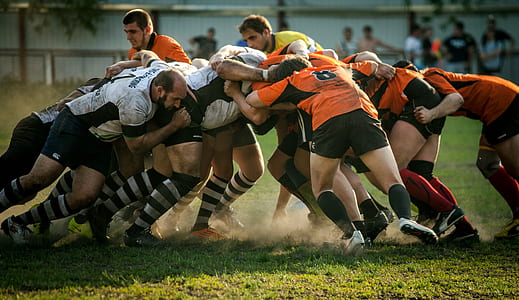 people in rugby game during daytime thumbnail
