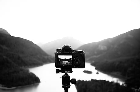 grayscale photography of camera and mountains thumbnail