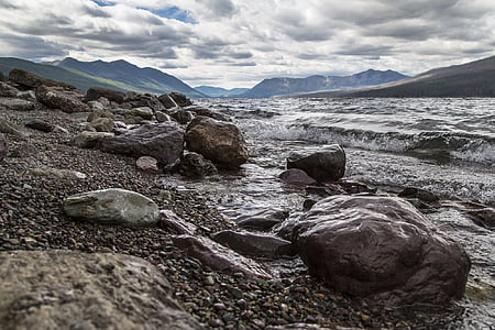 time-lapse photography of body of water near rocks thumbnail