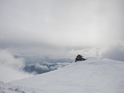 house on top of mountain covered with snow thumbnail