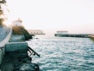 gray road beside body of water thumbnail
