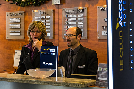 man and woman standing in front of LE Club front desk thumbnail