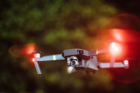 flying black drone during night thumbnail