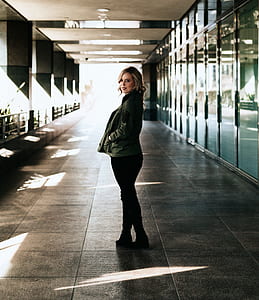 woman in jacket standing in building thumbnail